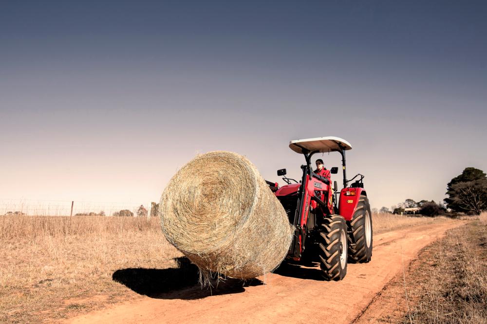 Case IH tractor carrying hay 