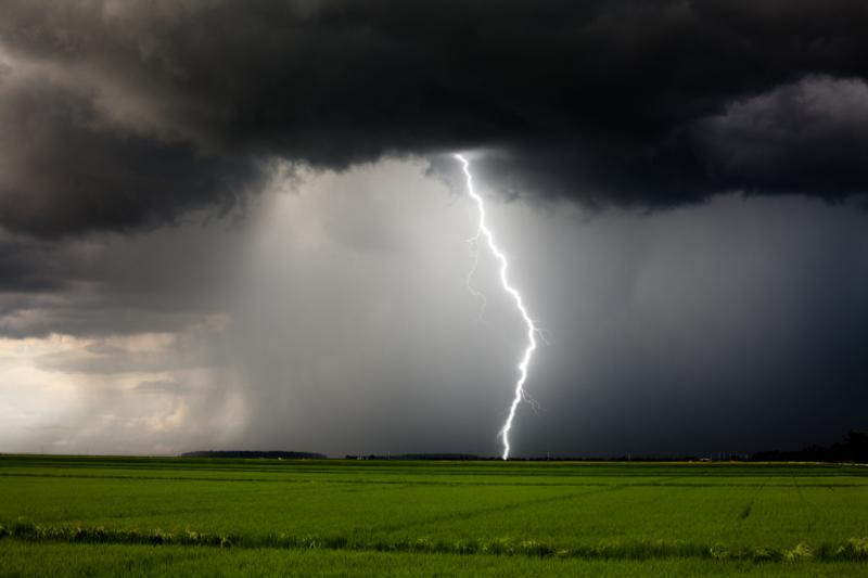 <img alt='Lightning and heavy rain from a strong thunderstorm during the day.'>